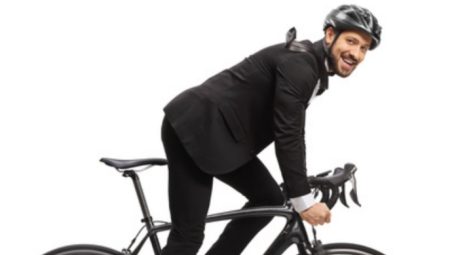 riding a bike in a business suit