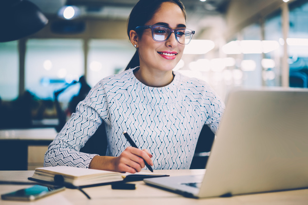 Smiling woman at her desk.