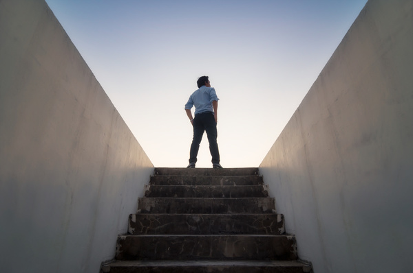 Standing at the top of stairs.