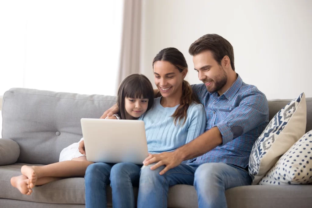family looking at a laptop together